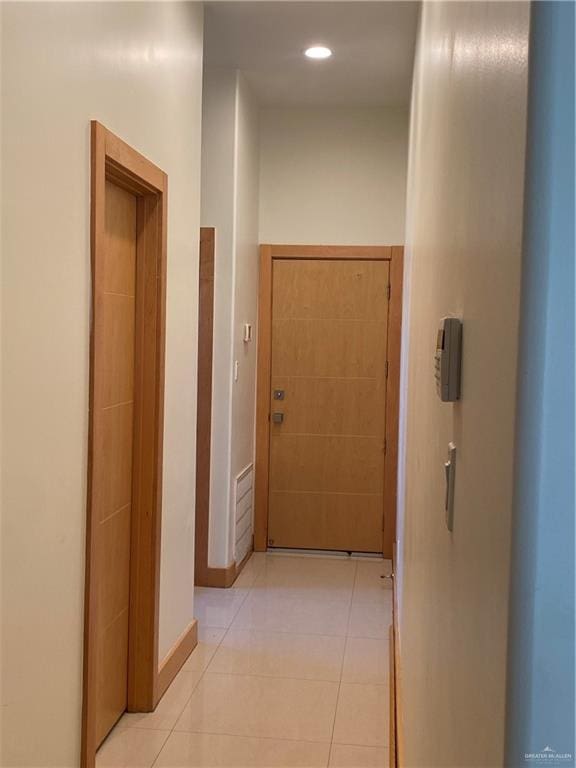 hallway featuring light tile patterned floors