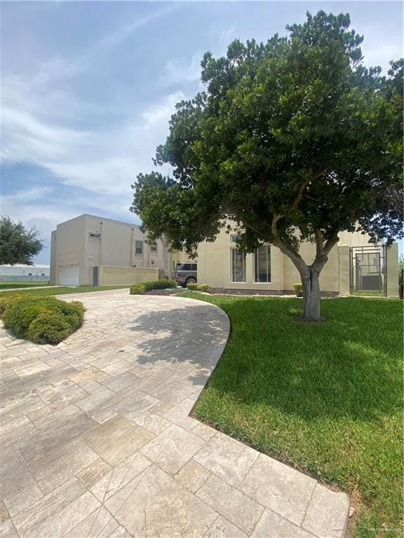 view of front of property featuring a garage and a front lawn