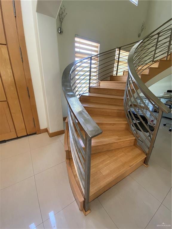 stairway with tile patterned flooring