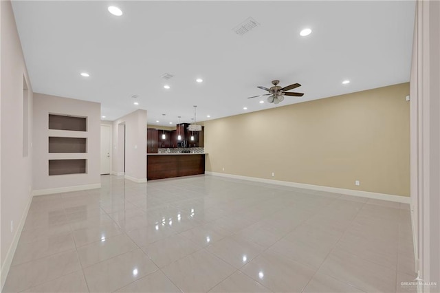 1425 Ozark Ave, Mcallen, TX 78504 - unfurnished living room with light tile patterned floors, a ceiling fan, baseboards, recessed lighting, and built in features