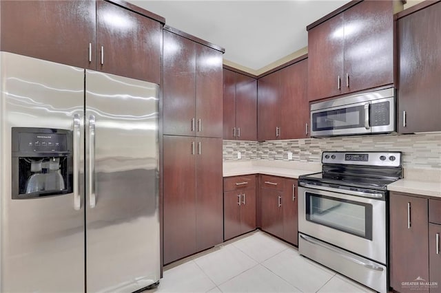 1425 Ozark Ave, Mcallen, TX 78504 - kitchen featuring stainless steel appliances, light countertops, light tile patterned flooring, decorative backsplash, and dark brown cabinets