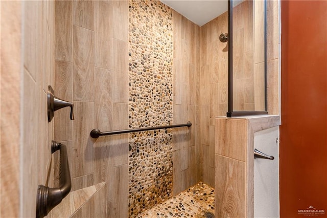 bathroom with tiled shower