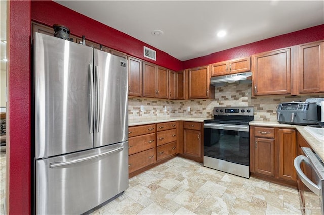 kitchen with tasteful backsplash and appliances with stainless steel finishes