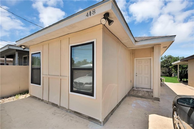 408 S 21st St, Mcallen, TX 78501 - view of exterior entry with a patio and board and batten siding