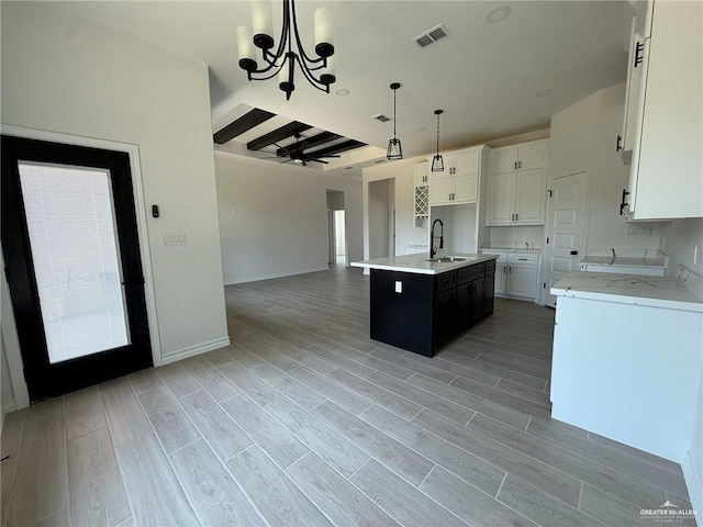 3614 Tecate St, Edinburg, TX 78542 - kitchen featuring a chandelier, open floor plan, white cabinetry, decorative light fixtures, and a center island with sink