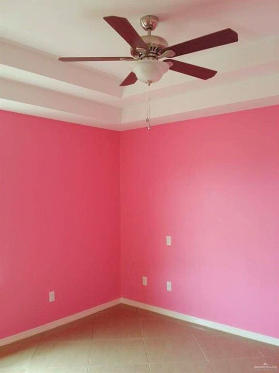 tiled empty room with ceiling fan