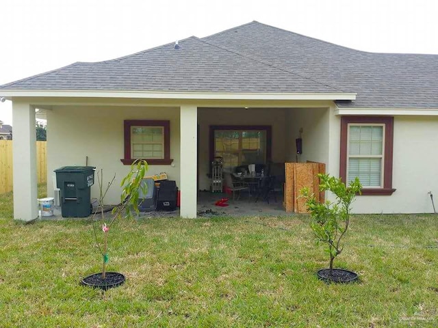 back of property featuring a lawn