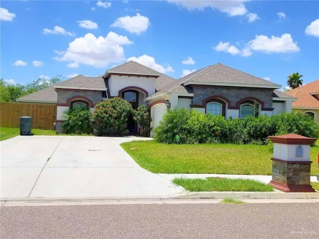 view of front of house featuring a front yard and a garage