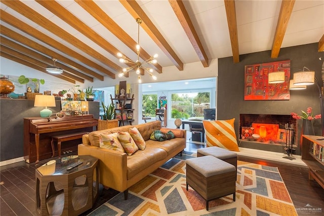 living room with baseboards, lofted ceiling with beams, wood finished floors, a fireplace, and a chandelier