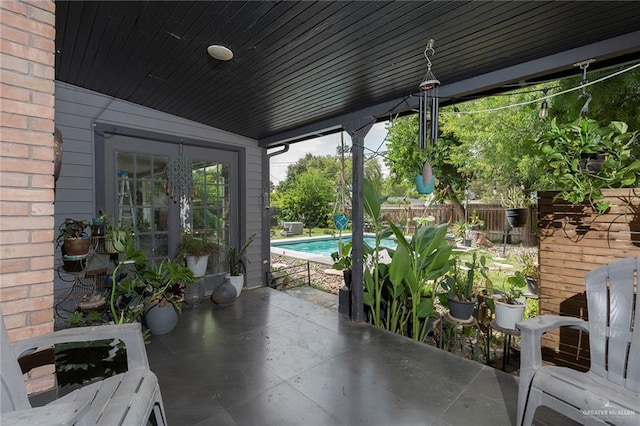 view of patio featuring fence and a fenced in pool