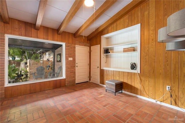 interior space featuring brick floor and wooden walls