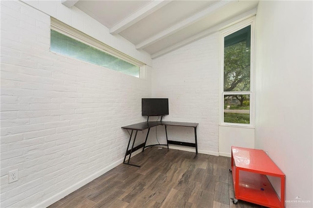 interior space with vaulted ceiling with beams, baseboards, dark wood finished floors, and brick wall