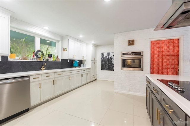 kitchen featuring light tile patterned floors, white cabinetry, light countertops, appliances with stainless steel finishes, and ventilation hood