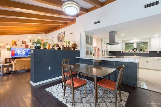 dining space featuring lofted ceiling with beams, an inviting chandelier, visible vents, and dark wood finished floors