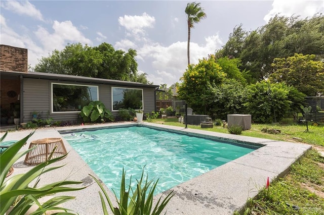 outdoor pool featuring fence