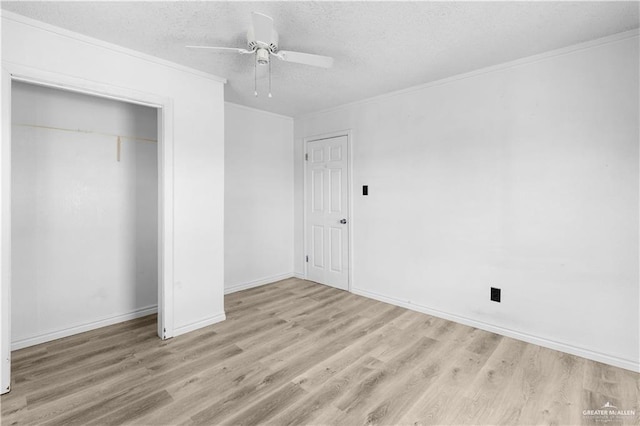 unfurnished bedroom featuring crown molding, wood finished floors, and a textured ceiling