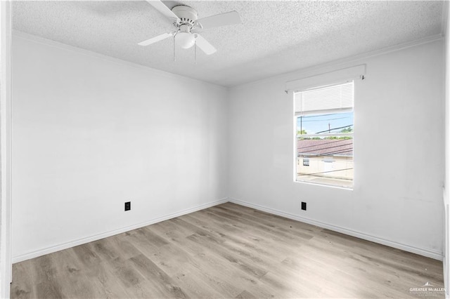 unfurnished room with crown molding, a textured ceiling, a ceiling fan, wood finished floors, and baseboards