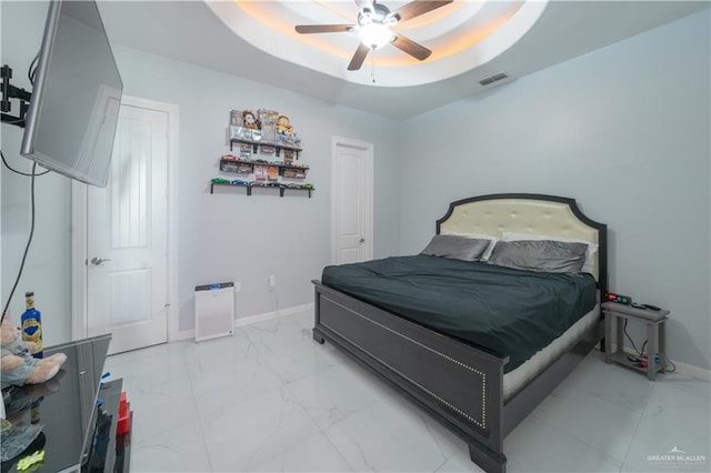 2511 Wisteria St, Rio Grande City, TX 78582 - bedroom featuring light marble finish floors, ceiling fan, and a tray ceiling