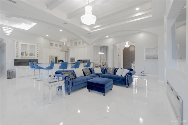 2511 Wisteria St, Rio Grande City, TX 78582 - living area with arched walkways, recessed lighting, light marble finish flooring, beam ceiling, and a raised ceiling