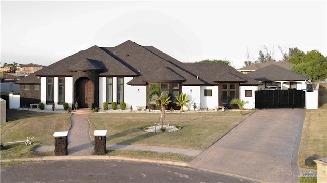 2511 Wisteria St, Rio Grande City, TX 78582 - french country style house featuring a front yard and driveway