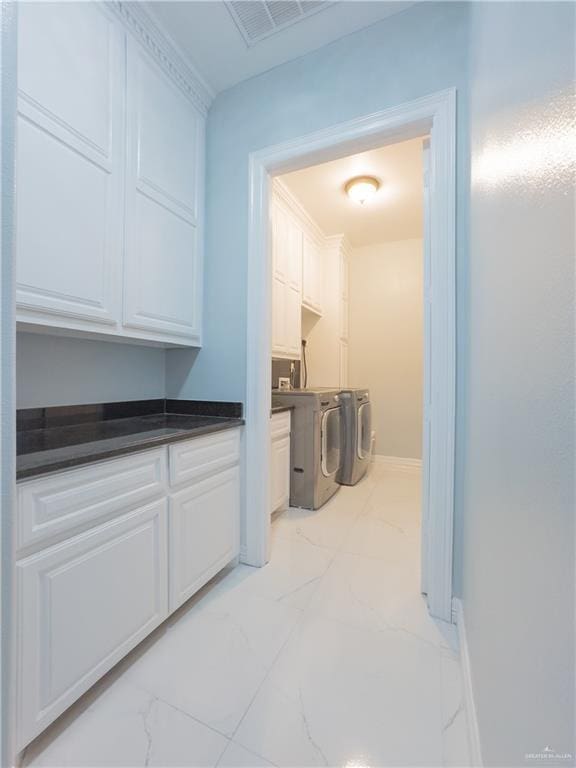 2511 Wisteria St, Rio Grande City, TX 78582 - washroom with washing machine and dryer, light marble finish floors, and cabinet space