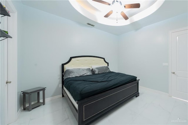 2511 Wisteria St, Rio Grande City, TX 78582 - bedroom with light marble finish floors, a tray ceiling, and ceiling fan