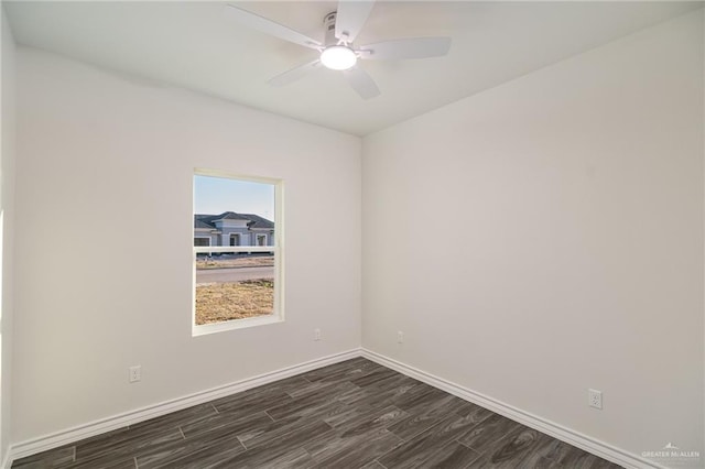 unfurnished room with dark wood-style floors, baseboards, and a ceiling fan