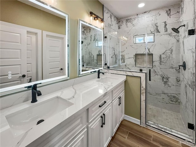 bathroom featuring vanity and a shower with door