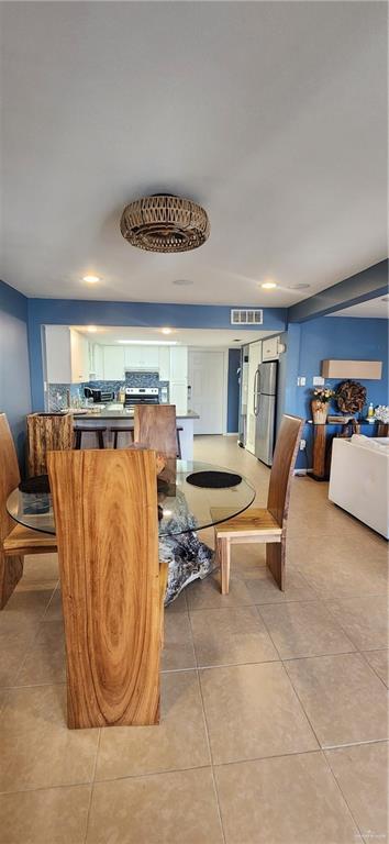 6201 Padre Blvd Unit 308, South Padre Island, TX 78597 - dining area with light tile patterned floors