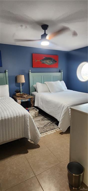 6201 Padre Blvd Unit 308, South Padre Island, TX 78597 - bedroom with tile patterned flooring and a ceiling fan