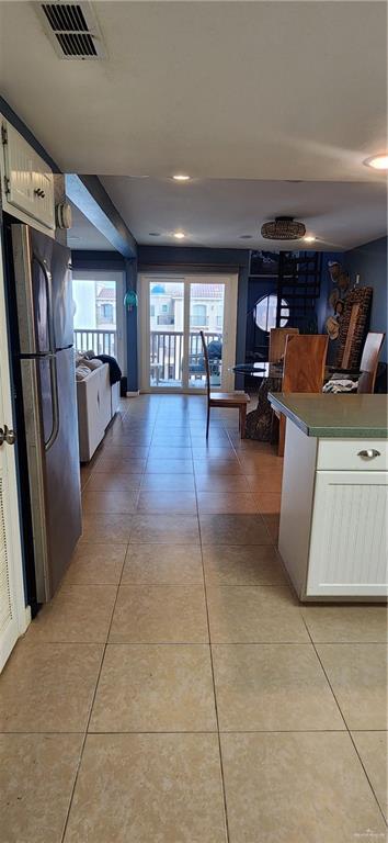 6201 Padre Blvd Unit 308, South Padre Island, TX 78597 - kitchen with freestanding refrigerator, white cabinets, light tile patterned flooring, and recessed lighting