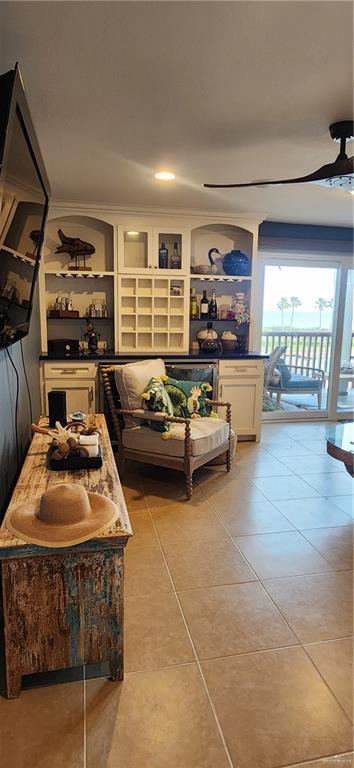 6201 Padre Blvd Unit 308, South Padre Island, TX 78597 - living area featuring light tile patterned floors and a ceiling fan