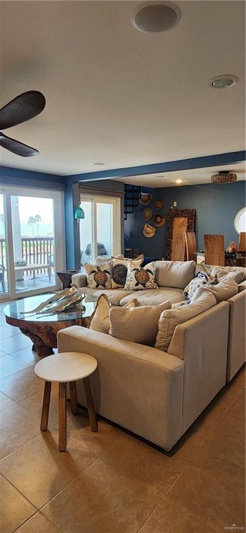 6201 Padre Blvd Unit 308, South Padre Island, TX 78597 - living room featuring light tile patterned floors and a ceiling fan
