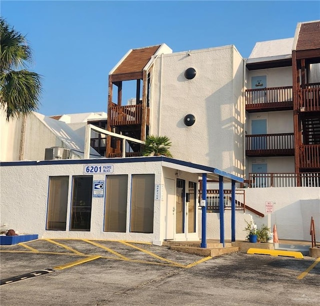 6201 Padre Blvd Unit 308, South Padre Island, TX 78597 - view of building exterior with uncovered parking