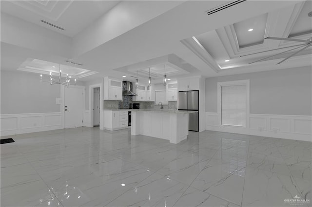 unfurnished living room featuring a raised ceiling and sink