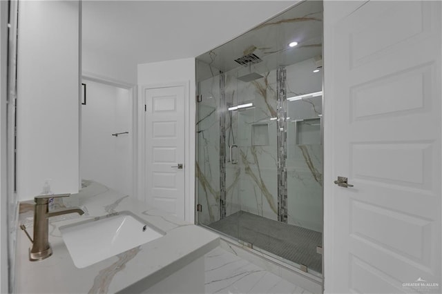 bathroom featuring vanity and a shower with shower door