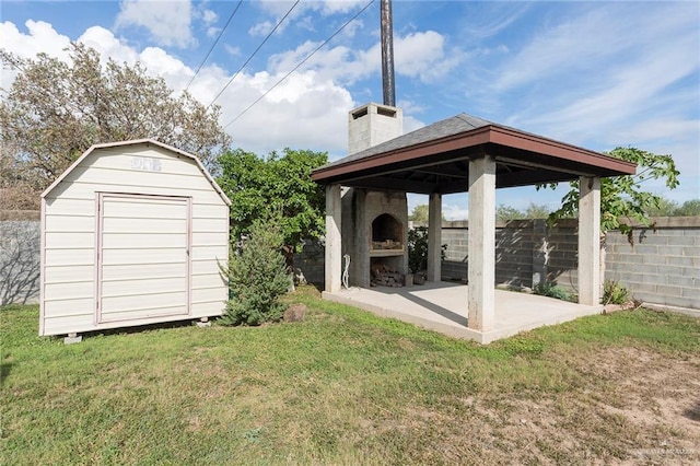 exterior space featuring an outbuilding, fence, a gazebo, a yard, and a chimney