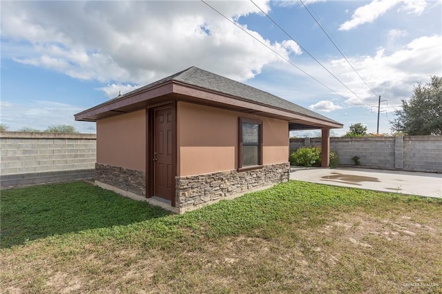 view of property exterior with a patio area and a yard