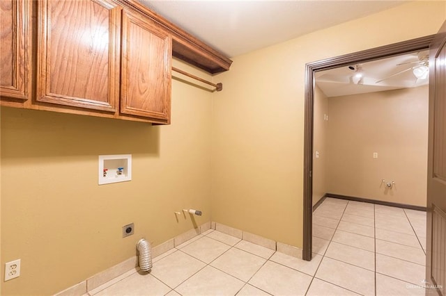 washroom with electric dryer hookup, cabinet space, light tile patterned floors, baseboards, and hookup for a washing machine