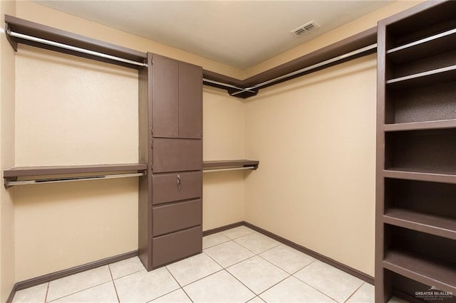 spacious closet featuring light tile patterned flooring and visible vents