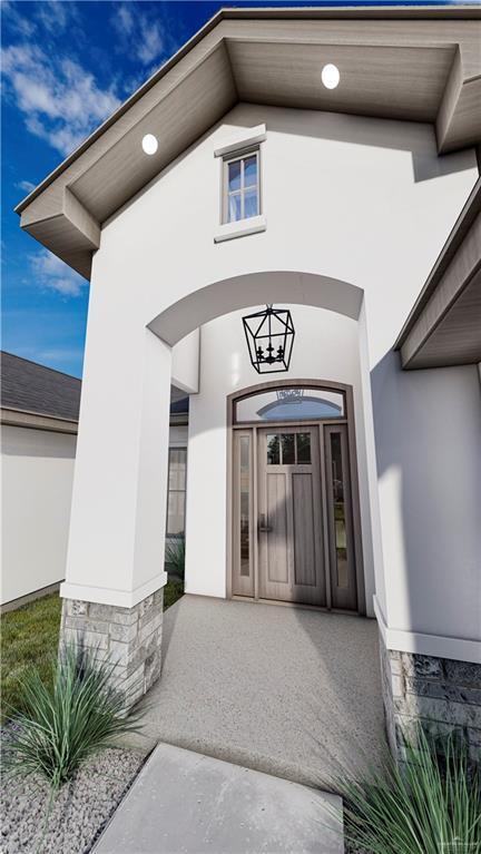 property entrance with stucco siding