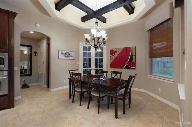 2703 Grand Canal Dr, Mission, TX 78572 - dining space featuring coffered ceiling, arched walkways, light tile patterned flooring, a chandelier, and french doors