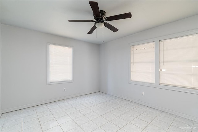 empty room featuring a ceiling fan and baseboards