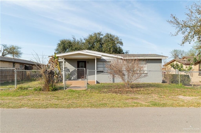 view of front of property with a fenced front yard, a front yard, a gate, and stucco siding