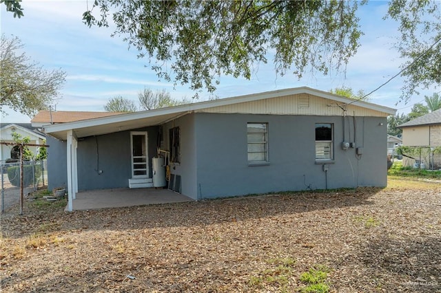 view of front of house with fence and gas water heater