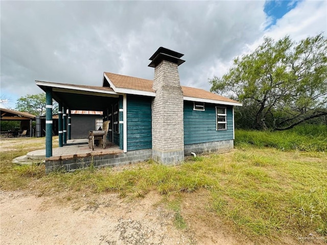 rear view of property with covered porch