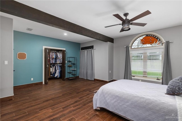 bedroom featuring ceiling fan, a closet, and beamed ceiling