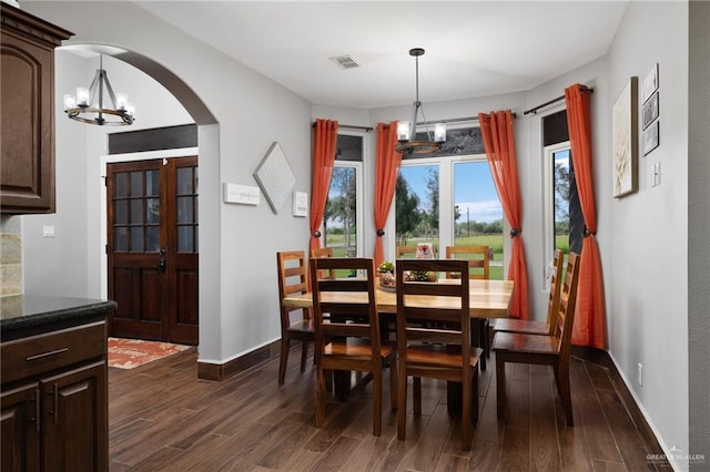 dining room featuring a chandelier and dark hardwood / wood-style flooring