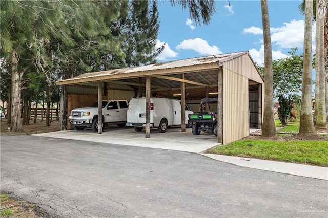 view of vehicle parking with a carport