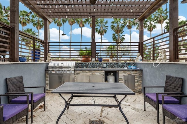 view of patio / terrace with a pergola, exterior kitchen, and grilling area